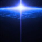 Earth's limb seen from orbit, lit by a vertical beam of light