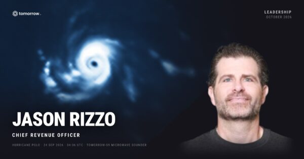 Jason Rizzo, Chief Revenue Officer of Tomorrow.io, beside a microwave satellite scan of Hurricane Polo's eye